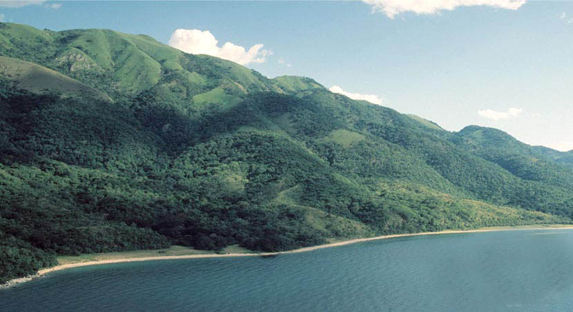 Expansive view of Lake Tanganyika with a mountainous background, showcasing Tanzania’s natural beauty