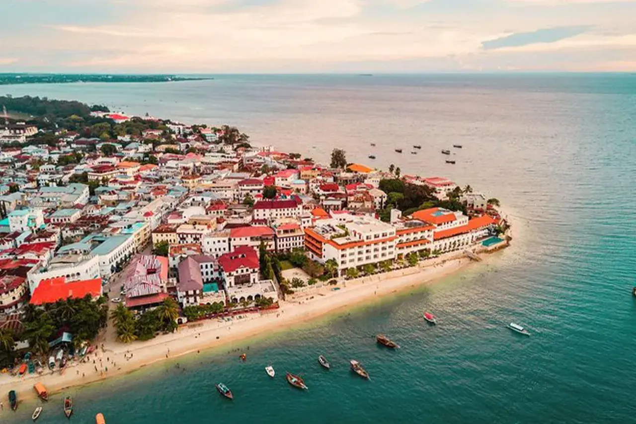 Aerial photograph of Stone Town, Zanzibar, displaying historic buildings and the Indian Ocean coastline.