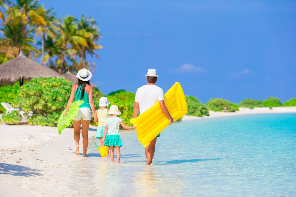 Family enjoying the beach in Zanzibar, relaxing by the ocean during their safari and beach escape.