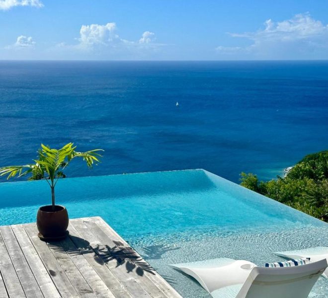 A luxury beachfront villa with an infinity pool overlooking the ocean.